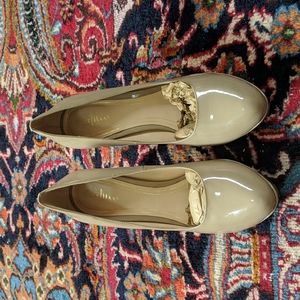 Nude Cole Haan patent leather platform pumps.